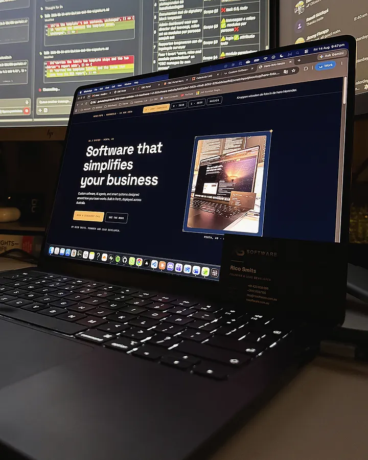 The RS Software homepage open on a laptop in the Perth office, next to a business card